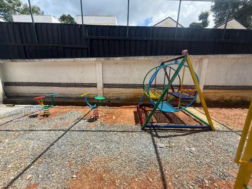 three childrens play equipment sitting on the ground at Empire Private Pool Villa in Kalpetta