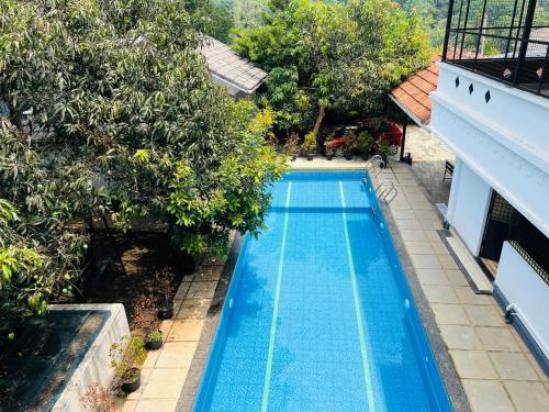 an overhead view of a swimming pool with trees at Empire Pool Villa in Meenangadi