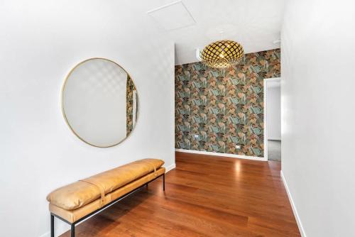 a room with a bench and a mirror on the wall at Queen Room at Wolfe Street in Whangarei