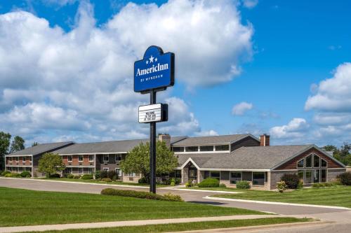 a blue street sign in front of a building at AmericInn by Wyndham Alexandria in Alexandria