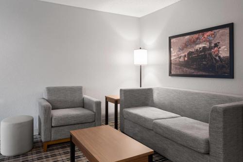 a living room with a couch and a chair at AmericInn by Wyndham Alexandria in Alexandria