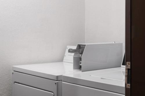 a fax machine sitting on top of white drawers at AmericInn by Wyndham Alexandria in Alexandria