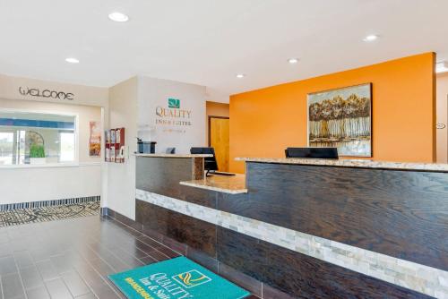 a lobby of a dental office with orange walls at Quality Inn & Suites Brandenburg - Fort Knox in Brandenburg