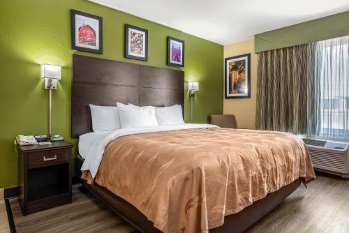 a hotel room with a large bed and a window at Quality Inn & Suites Brandenburg - Fort Knox in Brandenburg