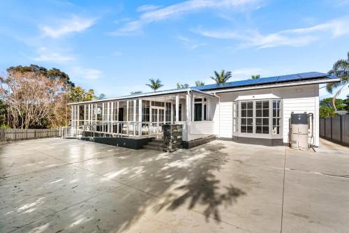 a large white house with a large patio at Twin Room at Wolfe Street in Whangarei