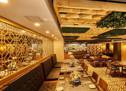a restaurant with tables and chairs in a room at Faranda Collection Cali, a member of Radisson Individuals in Cali