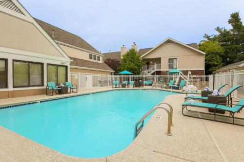 a large swimming pool with chairs and chairs in a house at MainStay Suites St Louis - Galleria in Richmond Heights
