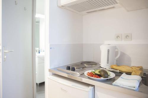 a kitchen with a plate of food on a counter at Comfort Aparthotel Besancon Hauts du Chazal in Besançon
