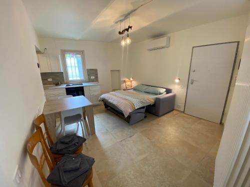 a bedroom with a bed and a desk in it at La tana della Volpe e l'Uva in La Morra
