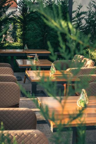 a row of tables and chairs with lights on them at Hotel Mažijanik in Nikšić