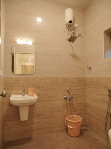 a bathroom with a sink and a toilet at Ganesh Residency 