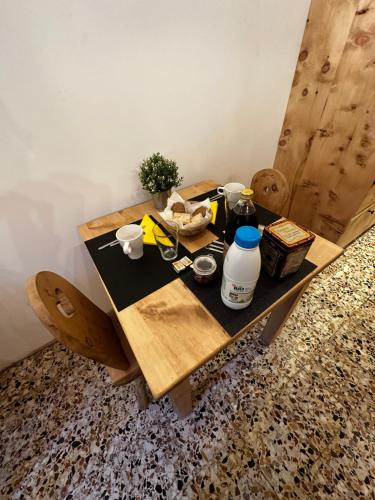 a wooden table with food and drinks on it at Maison Cœur Clarée in Névache