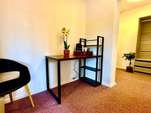 a black table with a plant on it in a room at Hotel Bergen Zur Post by Rikas Hotels in Bergen
