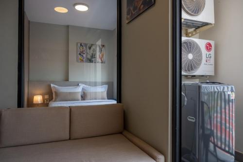 a bedroom with a bed and a mirror at PhnomPenh Apartment by The Star Polaris 23 Condo in Phnom Penh