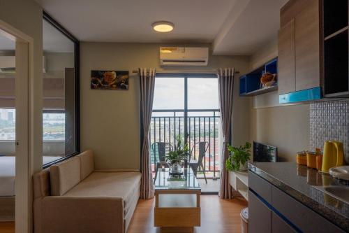 a living room with a couch and a table at PhnomPenh Apartment by The Star Polaris 23 Condo in Phnom Penh