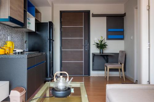 a kitchen with a door open to a dining room at PhnomPenh Apartment by The Star Polaris 23 Condo in Phnom Penh