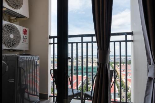 a room with a balcony with a view of the city at PhnomPenh Apartment by The Star Polaris 23 Condo in Phnom Penh
