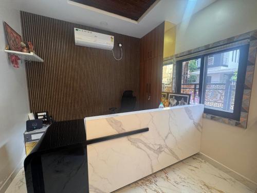 a bathroom with a marble counter and a window at MSK Homestay Service Apartments in Hubli