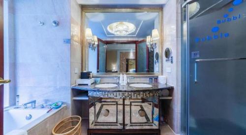a bathroom with two sinks and a large mirror at Fortune International Hotel in Xiawutun