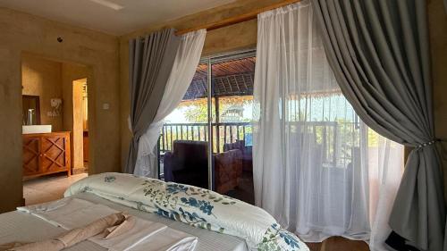 Кровать или кровати в номере Zanz Bay Hotel