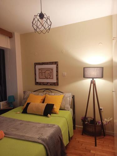 a bedroom with a green bed with a lamp at Efi's House in Florina