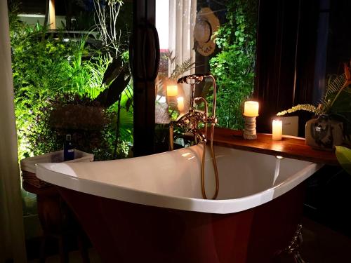 a bath tub in a room with plants at Fieldlight Pool Villa -Rice View &private pool云上稻影 in Mae Rim