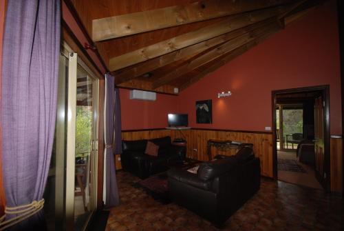 a living room with two couches and a television at Wrenwood Chalets in Augusta