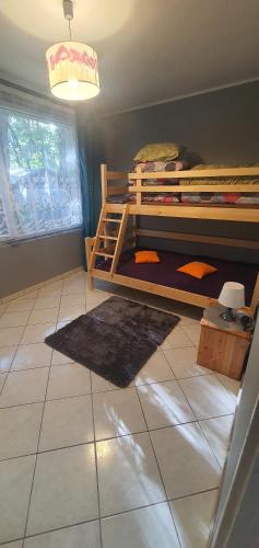 a room with two bunk beds and a tile floor at POD SOSNAMI Ośrodek Wypoczynkowy Boszkowo Letnisko in Boszkowo
