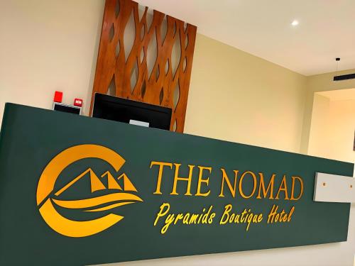 a sign for the nomedporateporate building trial at Pyramids Nomad View Hotel in Cairo