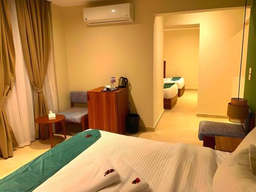 a hotel room with a bedroom with a bed and a mirror at Pyramids Nomad View Hotel in Cairo