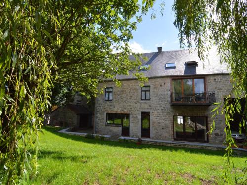 an exterior view of a brick house with a yard at Spacious Ardennes Getaway in Honnay