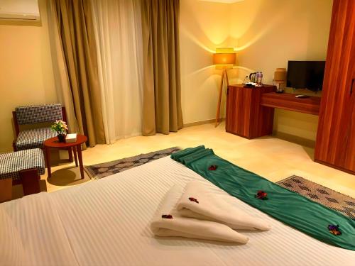 a hotel room with a bed with towels on it at Pyramids Nomad View Hotel in Cairo