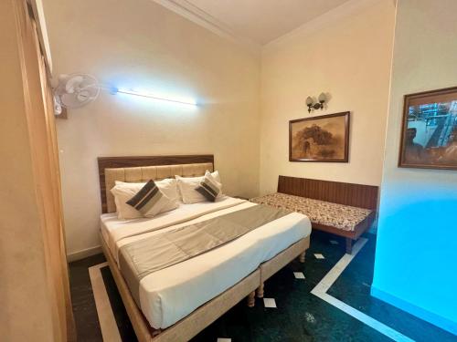 a bedroom with a bed and a table in it at asar CP Outer Circle by Orion Hotels in New Delhi