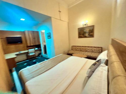 a hospital room with a bed and a couch at asar CP Outer Circle by Orion Hotels in New Delhi