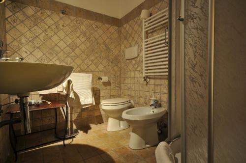 a bathroom with a toilet and a sink at Casale De Santis in Rome