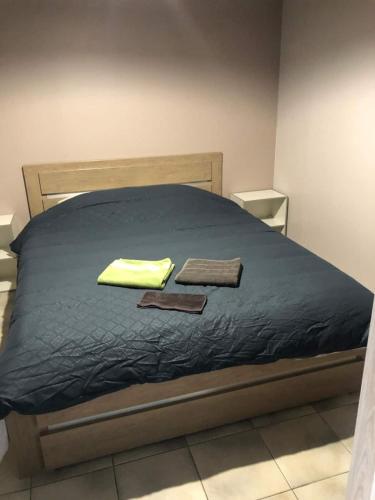 a bedroom with a bed with two towels on it at House, lot, secure private parking in Issoudun