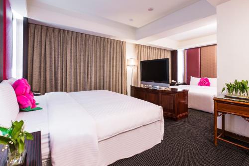 Un ou plusieurs lits dans un hébergement de l'établissement Han She Hotel
