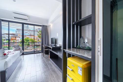 a hotel room with a kitchen and a living room at Z8 beach hotel in Jomtien Beach