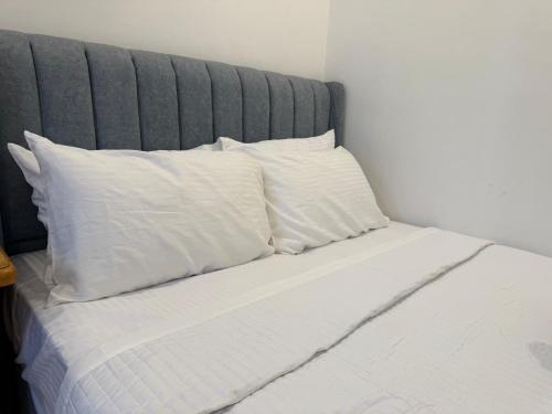 a bed with white pillows on top of it at Santai TTS BATU RAKIT in Kuala Terengganu
