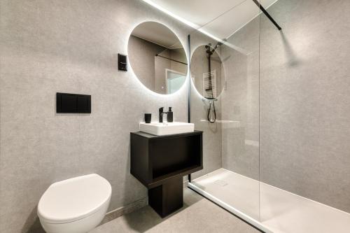 a bathroom with a toilet and a sink and a mirror at bsundrix Tiny Homes in Bludenz