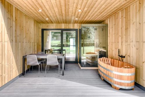 a room with a table and chairs on a deck at bsundrix Tiny Homes in Bludenz