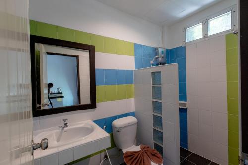 a bathroom with a sink and a toilet and a mirror at The Target Hotel chaingrai in Chiang Rai