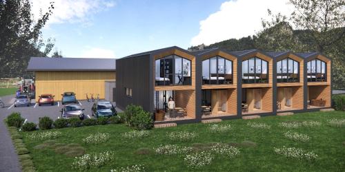 an architectural rendering of a building with cars parked in a parking lot at bsundrix Tiny Homes in Bludenz