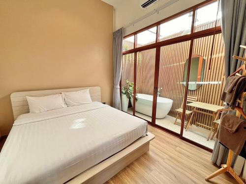 Postel nebo postele na pokoji v ubytování Bangsaen Cabana บางแสน คาบาน่า