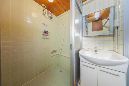 a bathroom with a sink and a shower at Mizusawa Green Hotel in Oshu