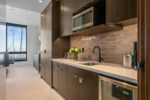 a kitchen with a sink and a microwave at Argent at Deer Valley Resort - Hotel Room #105A Hotel Room in Park City