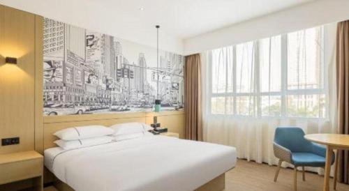 a bedroom with a large white bed and a window at City Comfort Inn Ji'an South Administrative Center in Ji'an