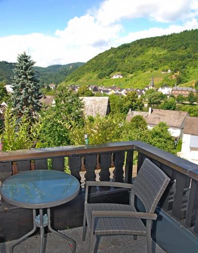 a table and chairs on a balcony with a view at Gästehaus Spies in Bullay