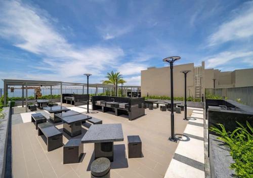 a patio with tables and benches on a building at The Song Boutique Aparment - Căn hộ Anh Kiet Home in Vung Tau