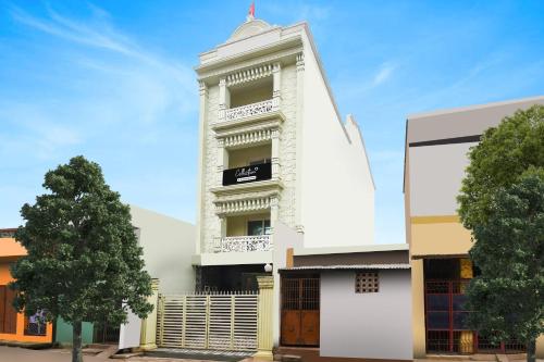 a white building with a clock tower at Super Collection O Paschim Dwar Near Jagannatha Temple in Puri